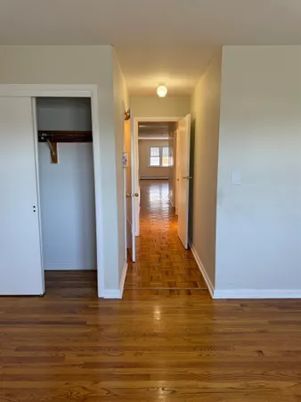 a view of a hallway with wooden floor