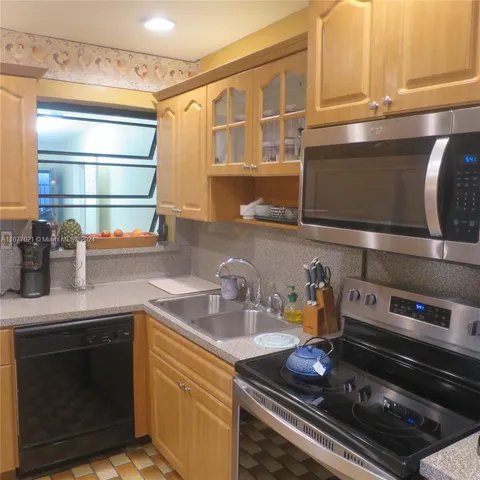 a kitchen with stainless steel appliances granite countertop a stove and a sink