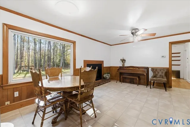 a dining room with furniture and a floor to ceiling window