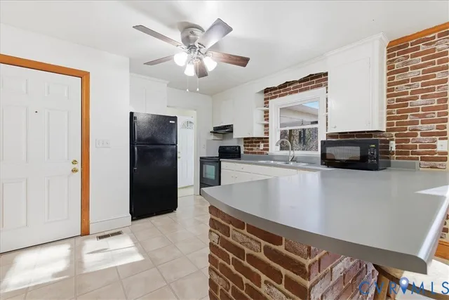 a kitchen with a refrigerator and a sink