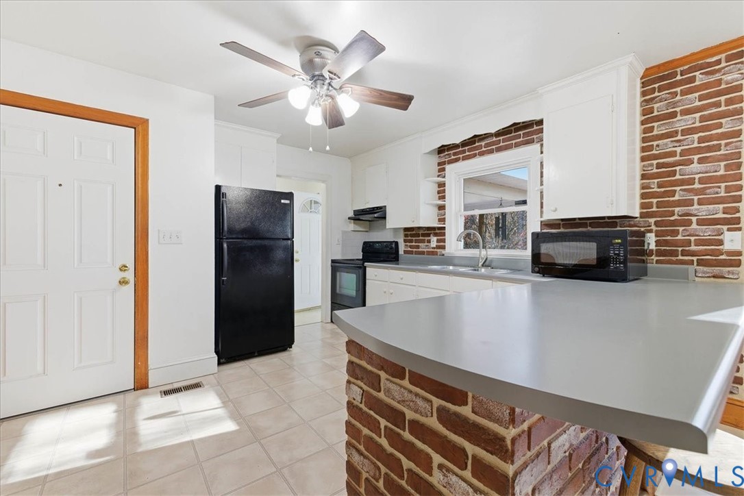 15357 Old Forty Road Waverly, VA 23890 - Photo 14 of 42 a kitchen with a refrigerator and a sink