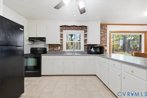 a kitchen with a refrigerator and a stove