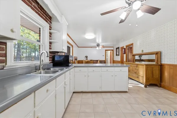 a kitchen with cabinets and window