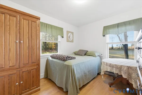 a bedroom with a bed and large window