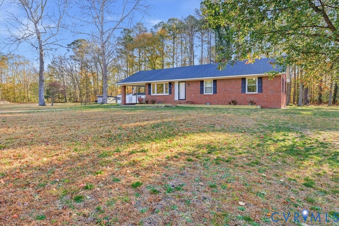 15357 Old Forty Road Waverly, VA 23890 - Photo 2 of 42 a view of a yard in front of a house with large trees