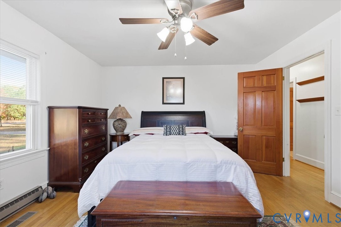 15357 Old Forty Road Waverly, VA 23890 - Photo 22 of 42 a bedroom with a bed and wooden floor
