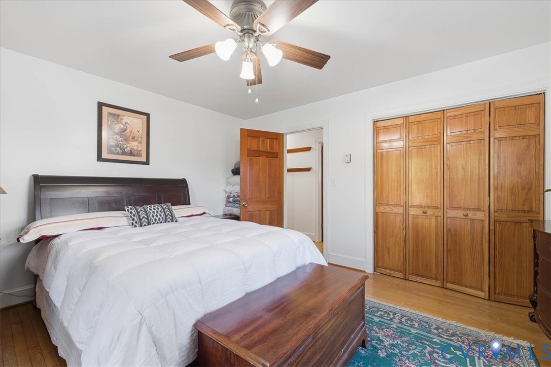 15357 Old Forty Road Waverly, VA 23890 - Photo 23 of 42 a bedroom with a large bed and a chandelier