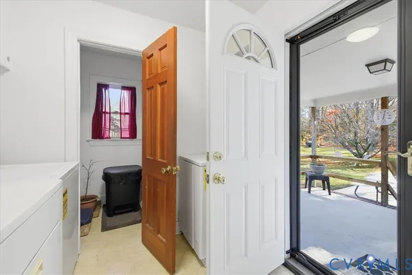 a view of a hallway and a livingroom with furniture