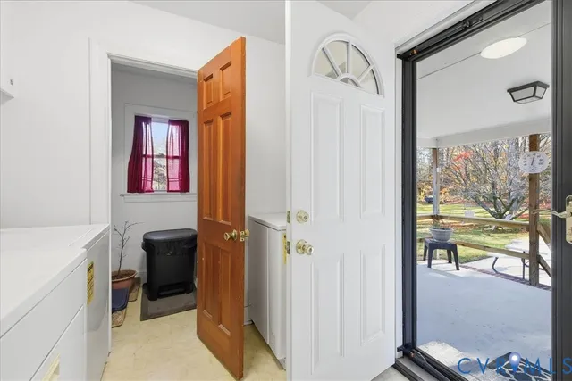 a view of a hallway and a livingroom with furniture