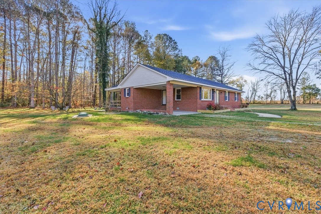 15357 Old Forty Road Waverly, VA 23890 - Photo 3 of 42 a view of a house with a big yard and large trees