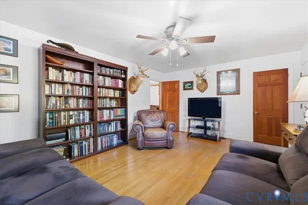 a living room with furniture and a book shelf