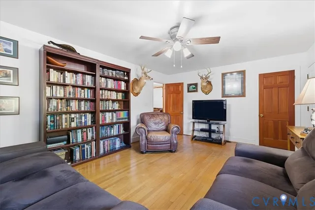 a living room with furniture and a book shelf