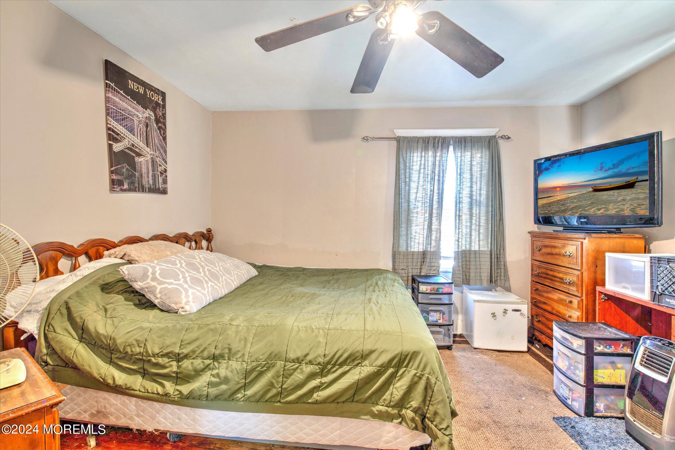 17 Club Place Freehold, NJ 07728 - Photo 15 of 27 a bedroom with a bed and a painting on the wall