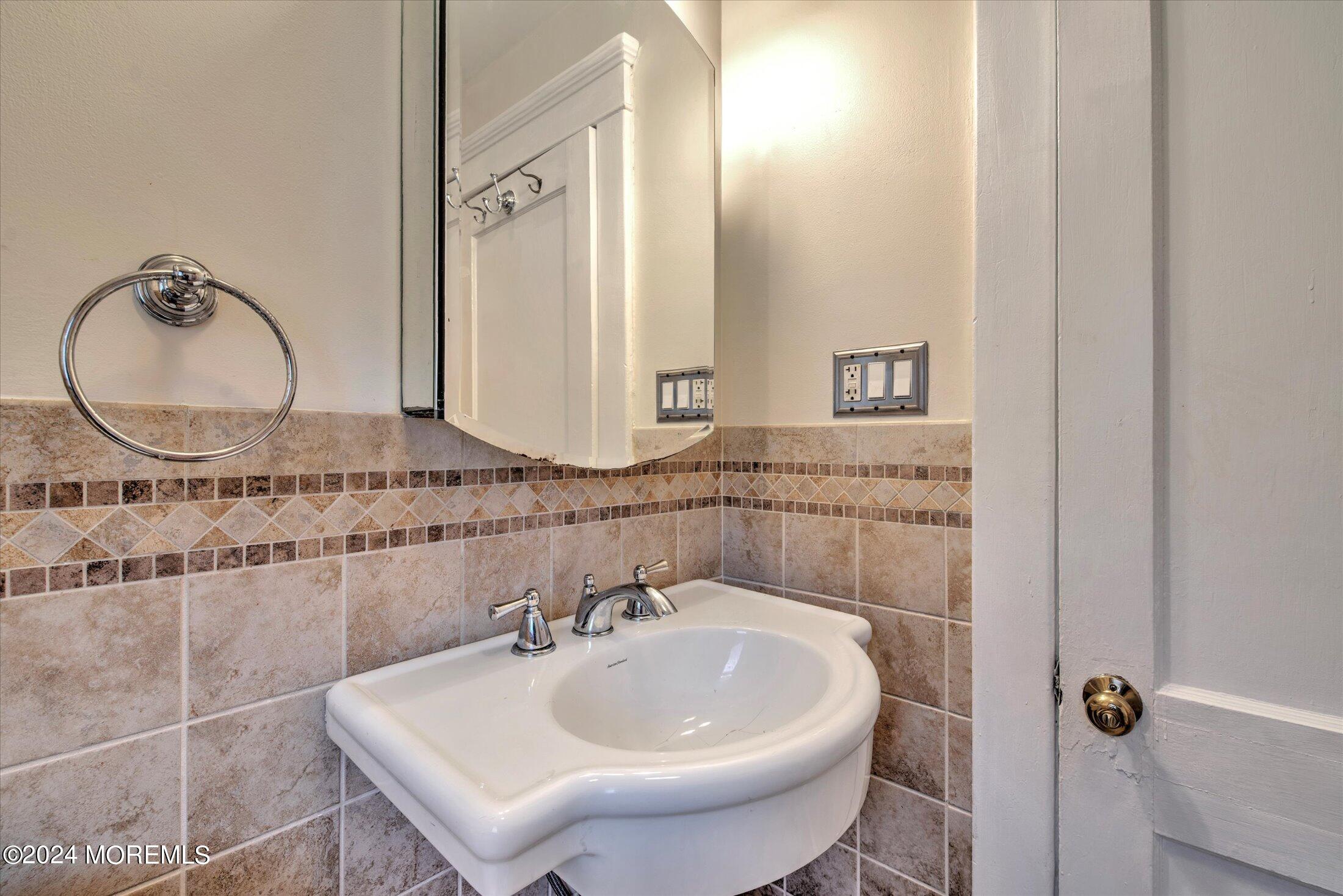 17 Club Place Freehold, NJ 07728 - Photo 18 of 27 a bathroom with a sink and a mirror