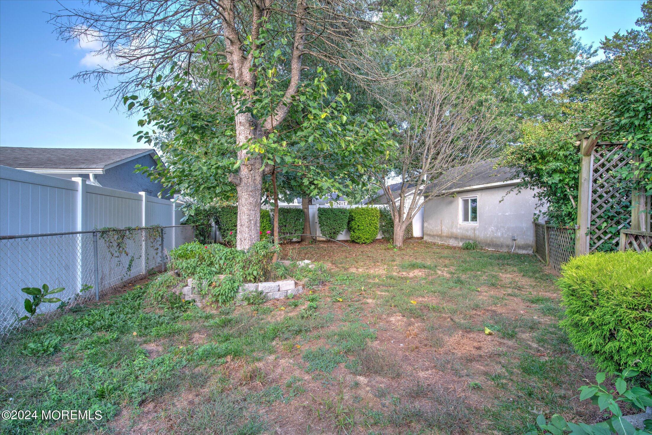 17 Club Place Freehold, NJ 07728 - Photo 22 of 27 a view of a house with yard and a garden