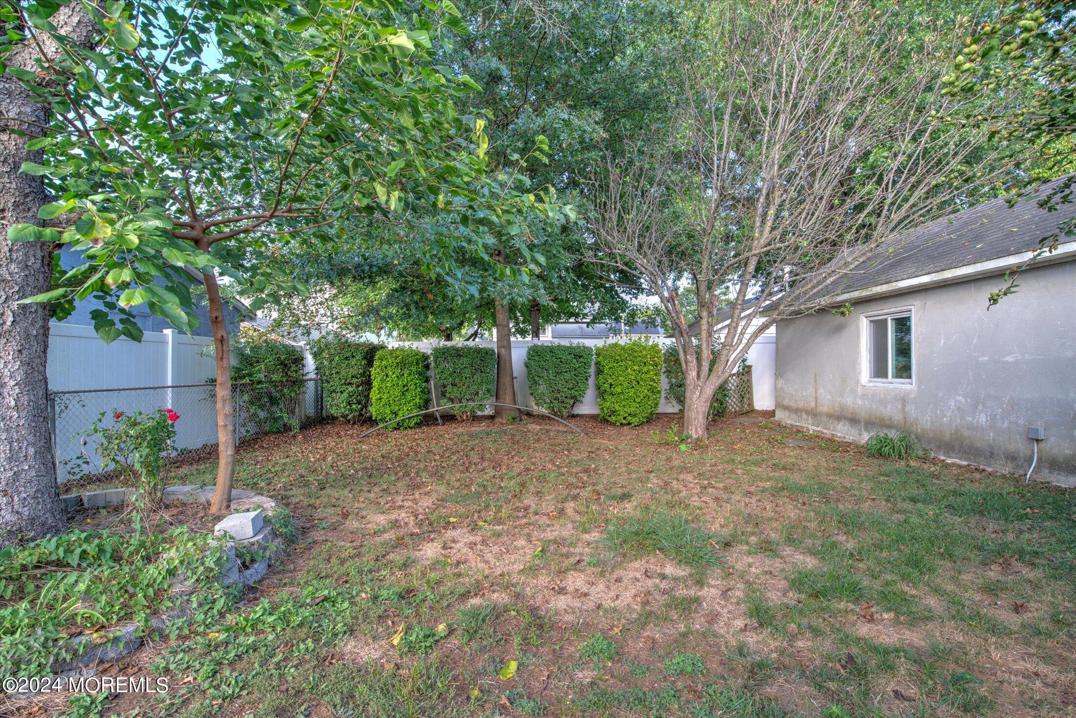 17 Club Place Freehold, NJ 07728 - Photo 23 of 27 a view of a house with a yard and garage