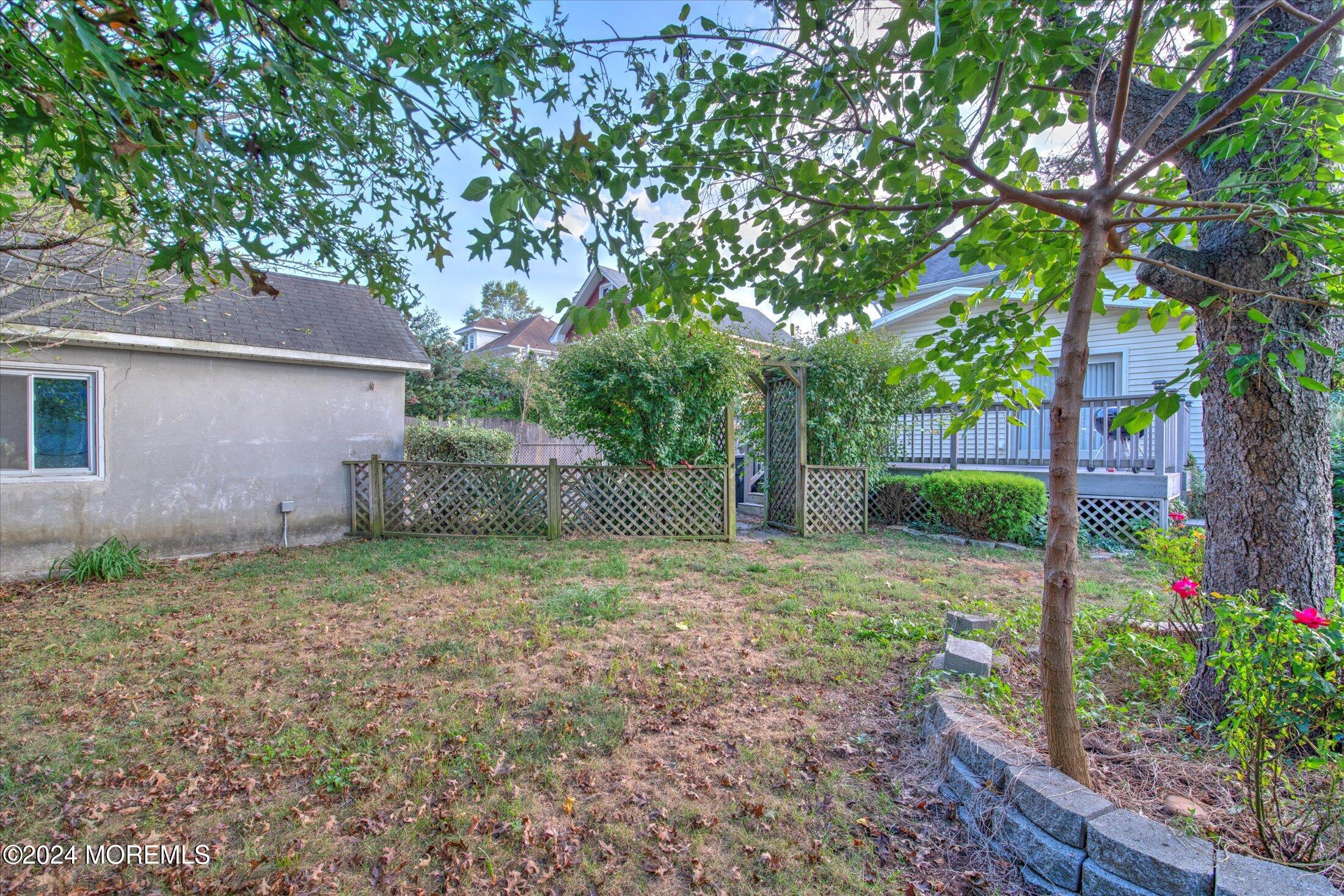 17 Club Place Freehold, NJ 07728 - Photo 25 of 27 a backyard of a house with plants and tree
