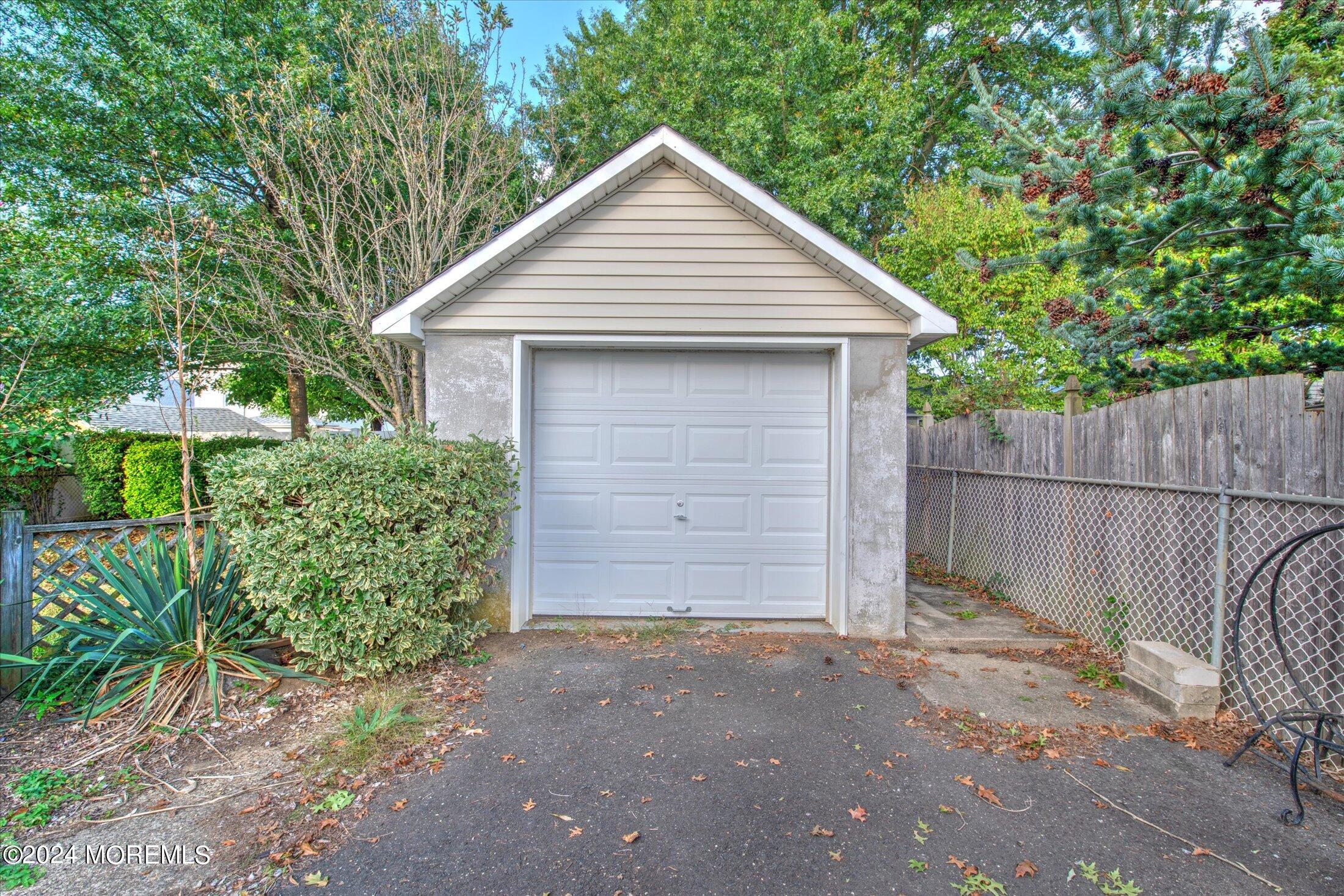 17 Club Place Freehold, NJ 07728 - Photo 26 of 27 a front view of house with yard and trees