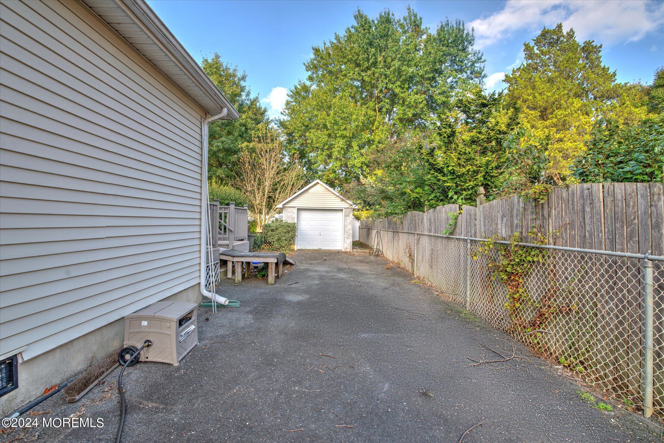 17 Club Place Freehold, NJ 07728 - Photo 27 of 27 a view of backyard with small cabin and wooden fence