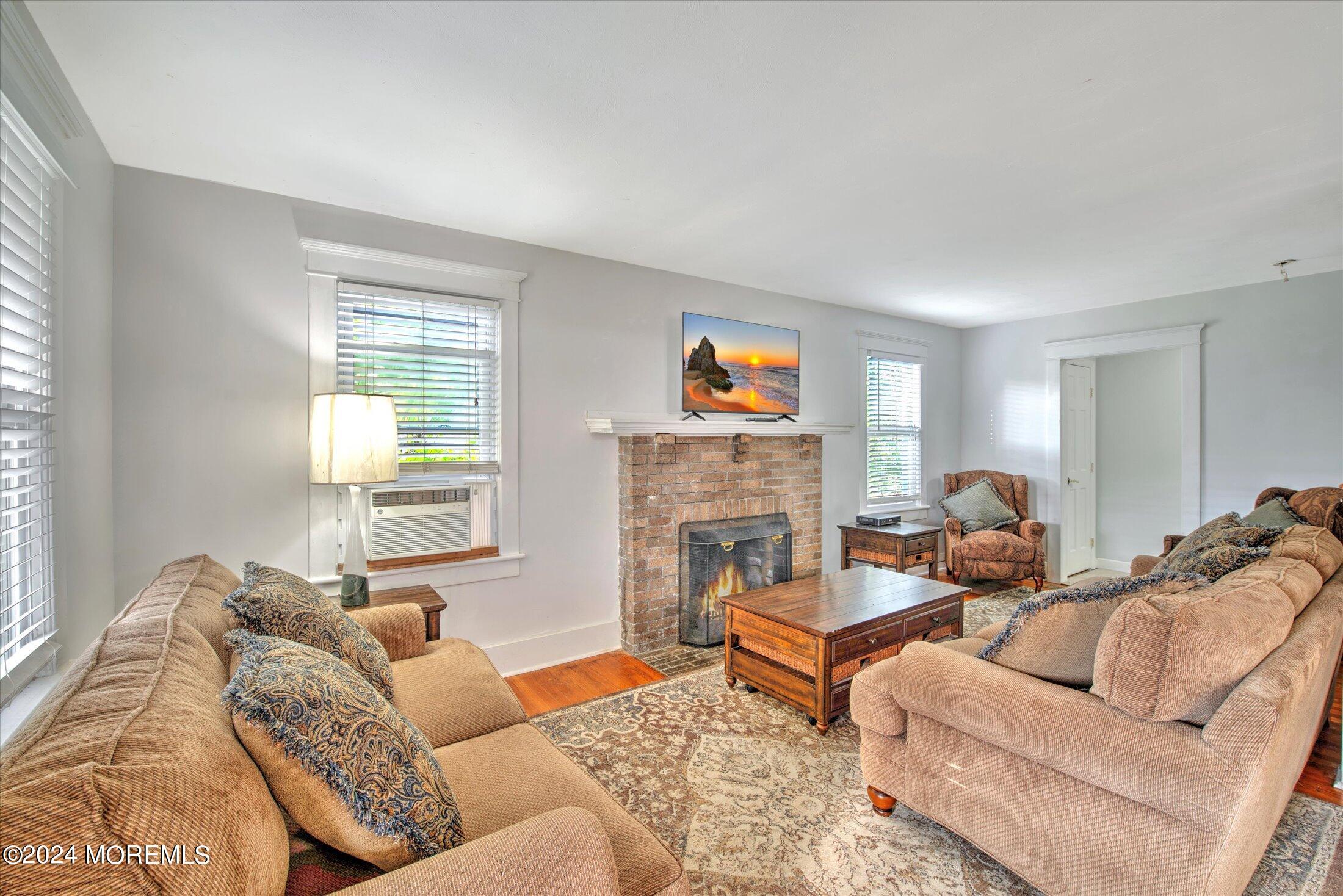 17 Club Place Freehold, NJ 07728 - Photo 3 of 27 a living room with furniture and a fireplace