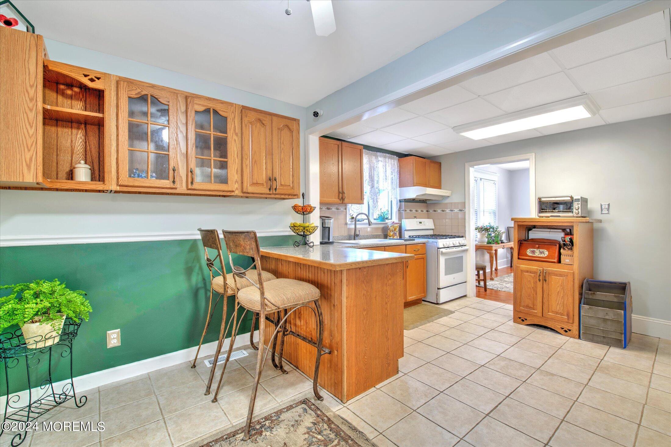 17 Club Place Freehold, NJ 07728 - Photo 7 of 27 a kitchen with stainless steel appliances granite countertop a stove top oven a sink dishwasher and a refrigerator