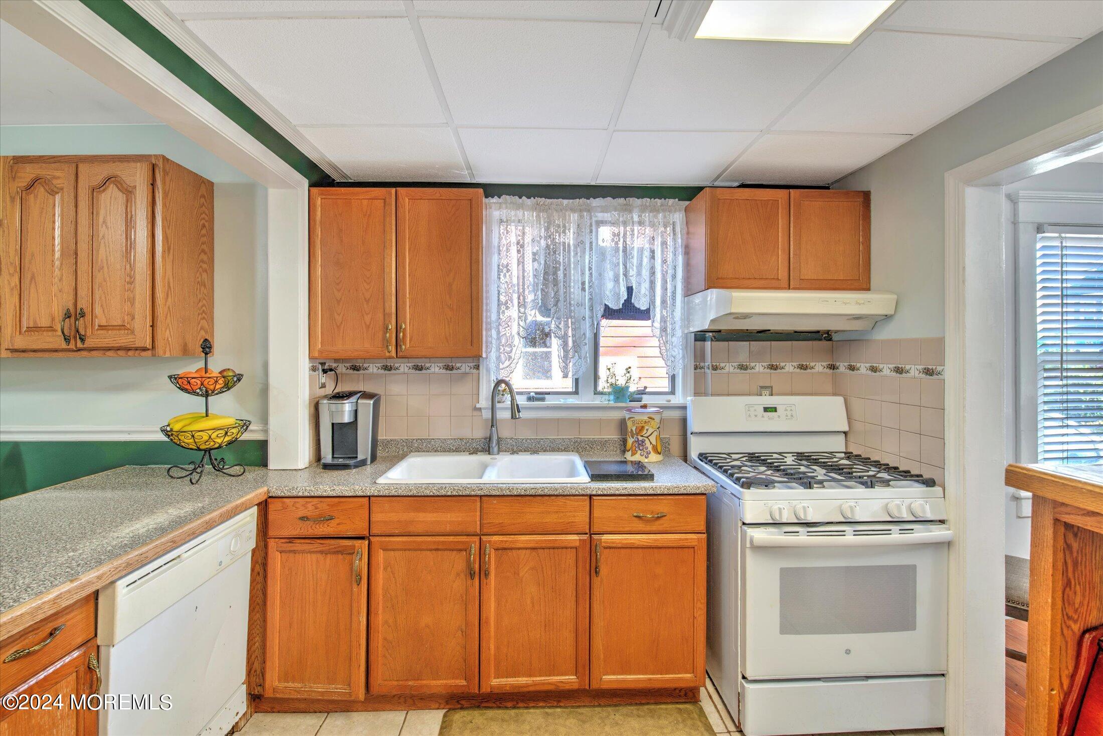 17 Club Place Freehold, NJ 07728 - Photo 8 of 27 a kitchen with stainless steel appliances granite countertop a sink stove and cabinets