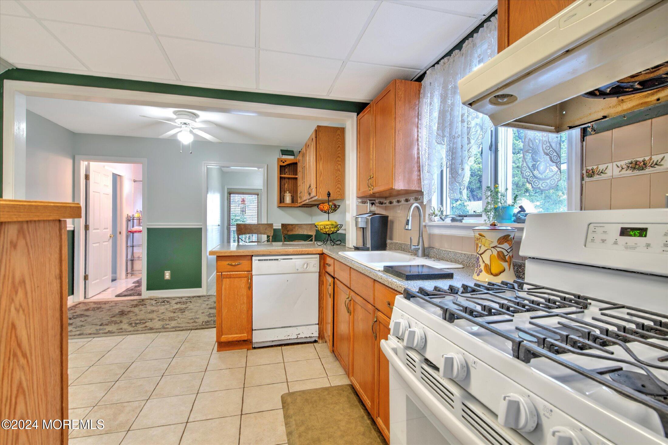 17 Club Place Freehold, NJ 07728 - Photo 9 of 27 a kitchen with stainless steel appliances granite countertop a stove a sink and a refrigerator