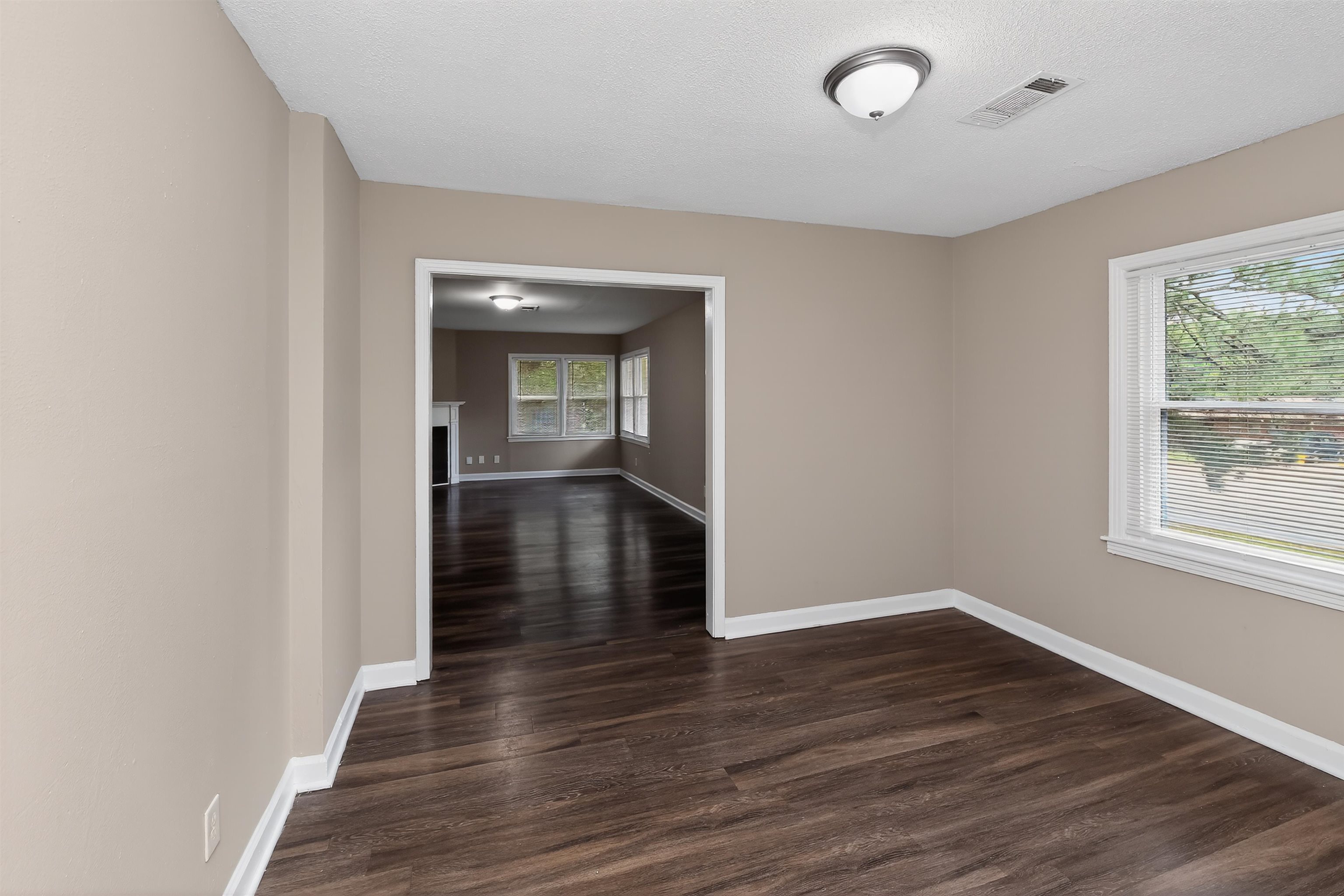 318 East Raines Road Memphis, TN 38109 - Photo 12 of 28 Interior space featuring wood-finish flooring, neutral wall paint, white trim, and a semi-flush mount ceiling light fixture