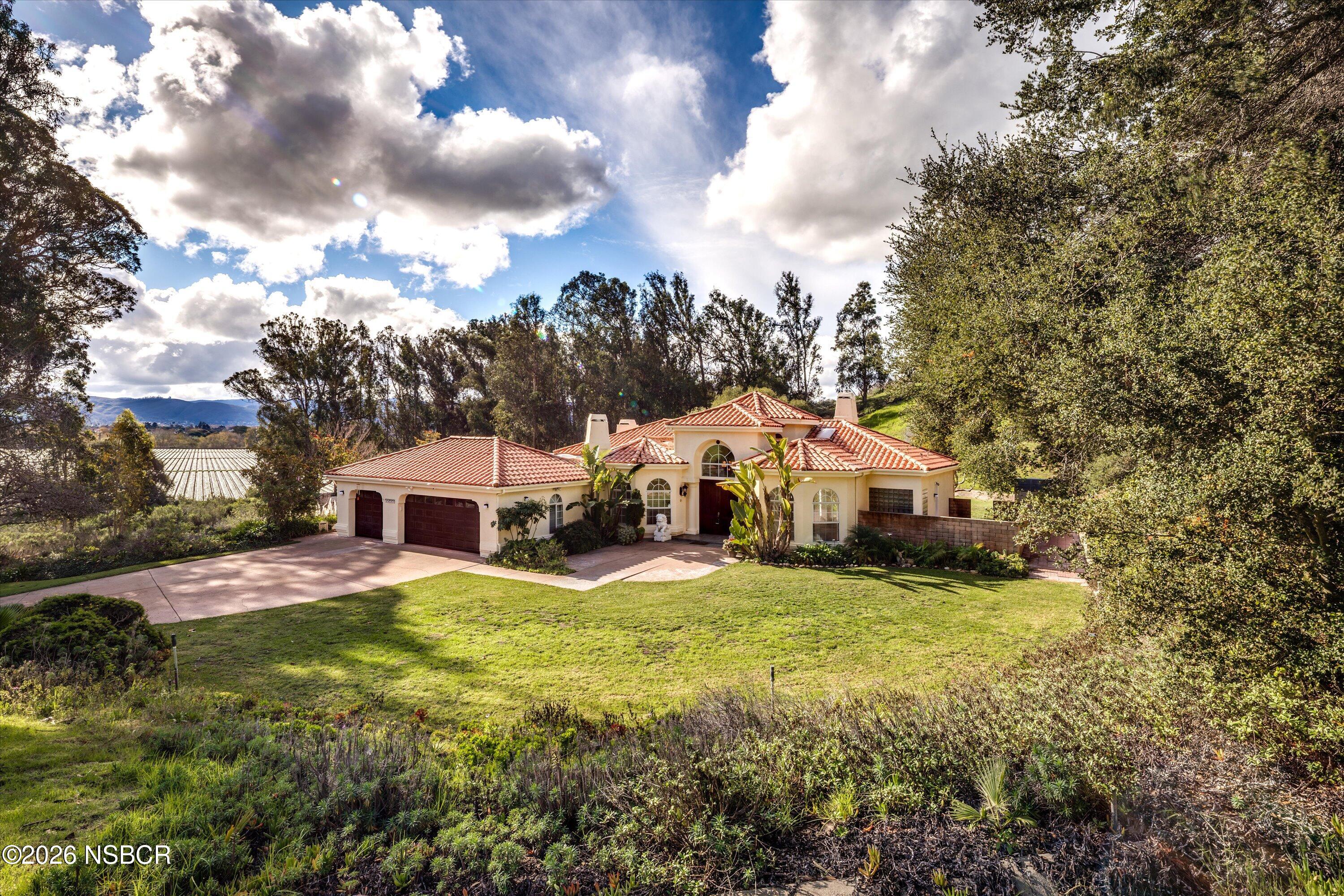 2655 Adobe Falls Road Lompoc, CA 93436 - Photo 8 of 51 a view of a house with a big yard and large trees