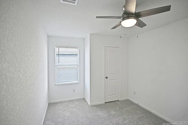 an empty room with a fan