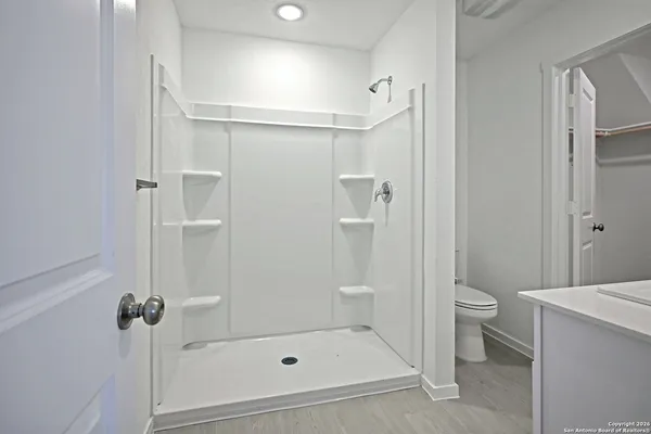 a bathroom with a shower and a toilet
