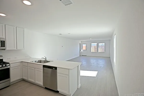 a kitchen with a sink and cabinets