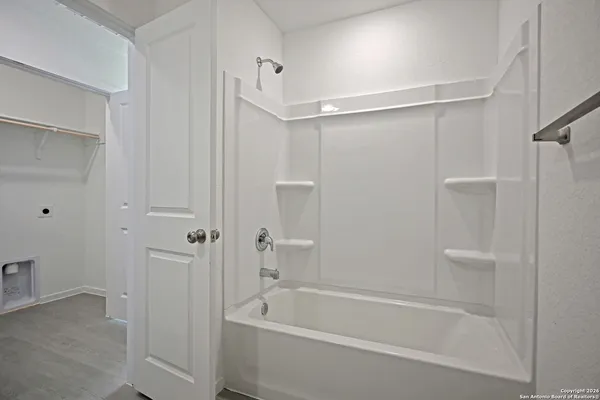 a bathroom with a bathtub and a shower