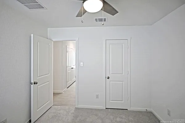 wooden floor with cabinet and mirror