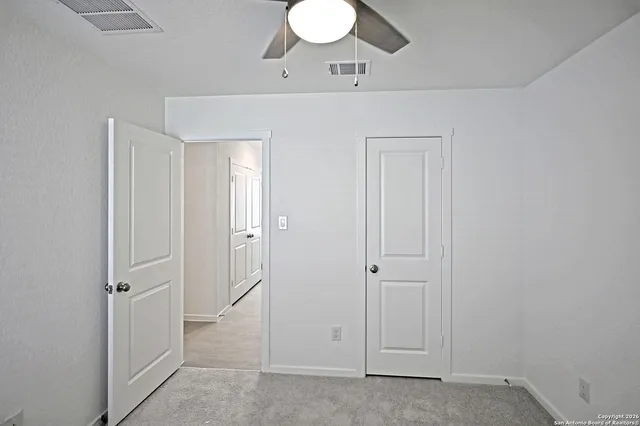 wooden floor with cabinet and mirror