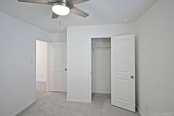 a view of a livingroom with a chandelier fan