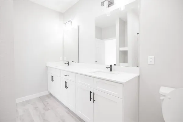 a white toilet sitting next to a shower