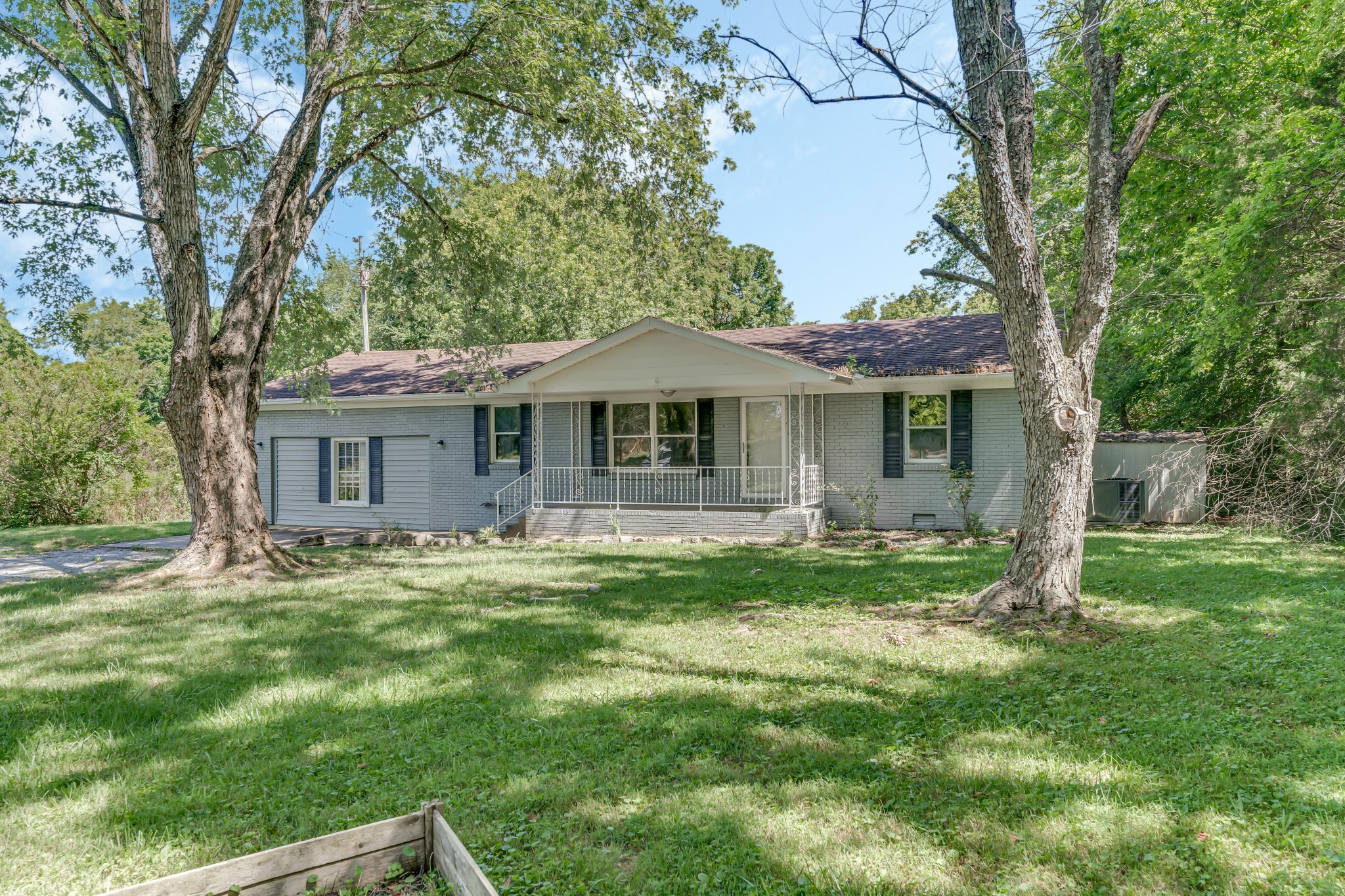 a front view of a house with a garden