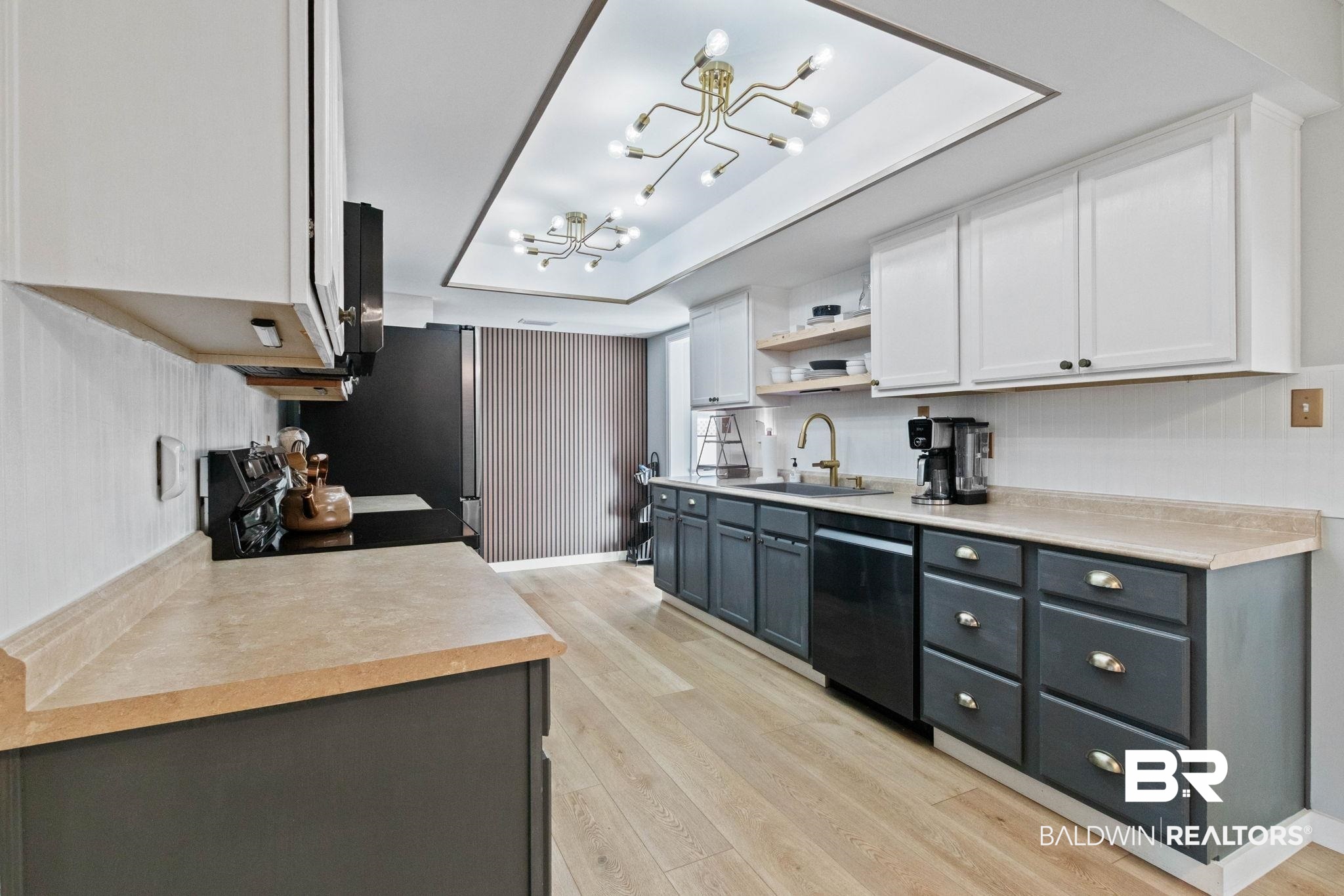 524 Ariel Avenue Foley, AL 36535 - Photo 10 of 37 Kitchen featuring two-tone cabinetry with white upper cabinets and dark lower cabinets, light wood-finish flooring, recessed ceiling lighting, and a gold-tone faucet