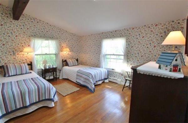89 Shore Road Harwich, MA 02671 - Photo 15 of 20 a bedroom with a bed and wooden floor