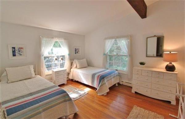 89 Shore Road Harwich, MA 02671 - Photo 17 of 20 a bedroom with a bed and wooden floor