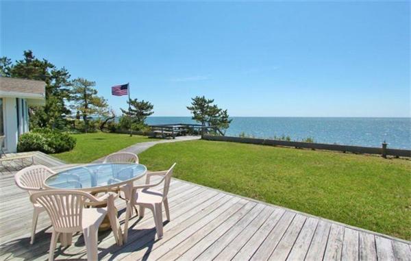 89 Shore Road Harwich, MA 02671 - Photo 2 of 20 a view of a chair and table on the wooden floor