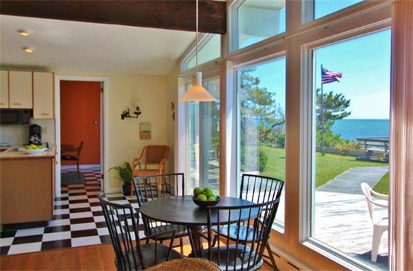 89 Shore Road Harwich, MA 02671 - Photo 10 of 20 a dining room with furniture large windows and wooden floor