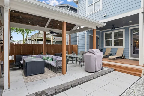 a building outdoor space with patio furniture and potted plants