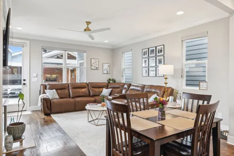 a living room with furniture a chandelier and a table