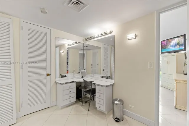 a bathroom with a sink a toilet a mirror and shower