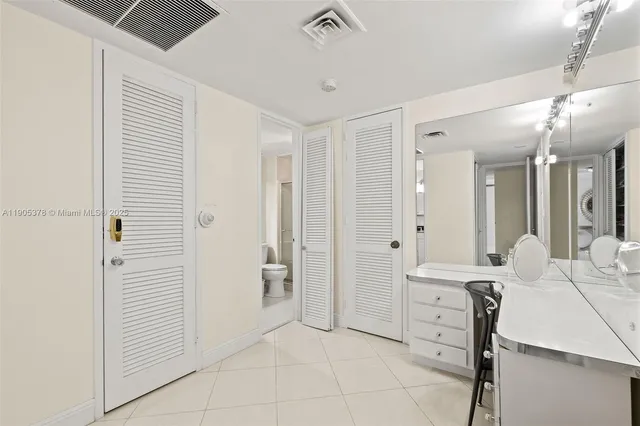 a spacious bathroom with a double vanity sink a mirror and a shower