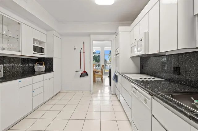 a kitchen with stainless steel appliances granite countertop a sink and cabinets