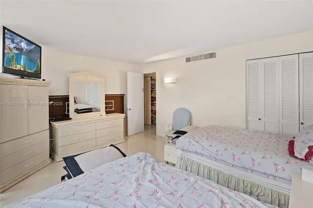 a bedroom with a bed and a view of kitchen