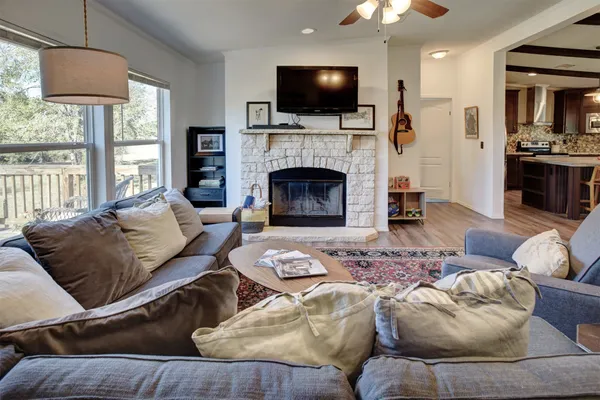 a living room with furniture fireplace and flat screen tv